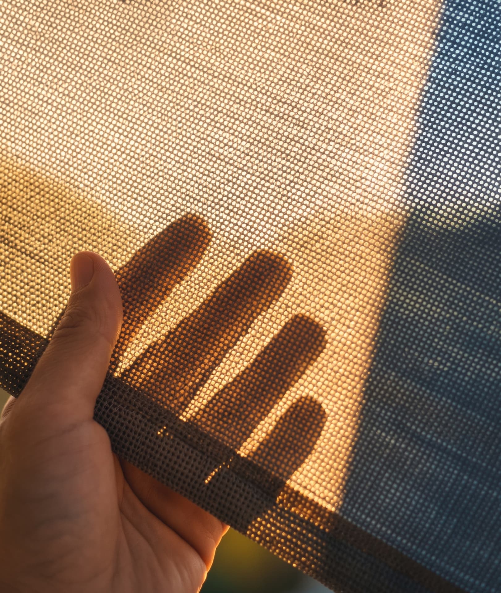 Shade fabric illustration for Frisco, TX: close-up of woven screen mesh in sunlight
